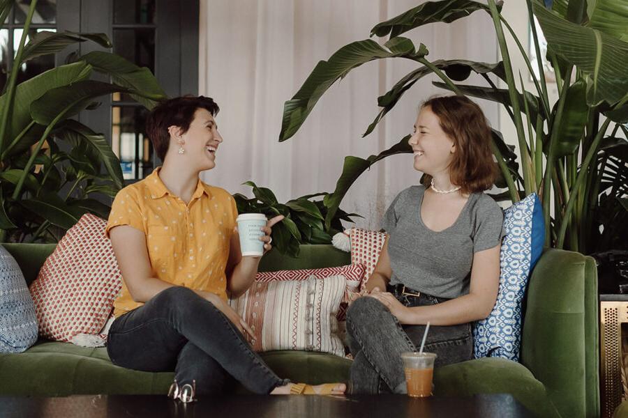 Two PBA students talk in a coffee shop.